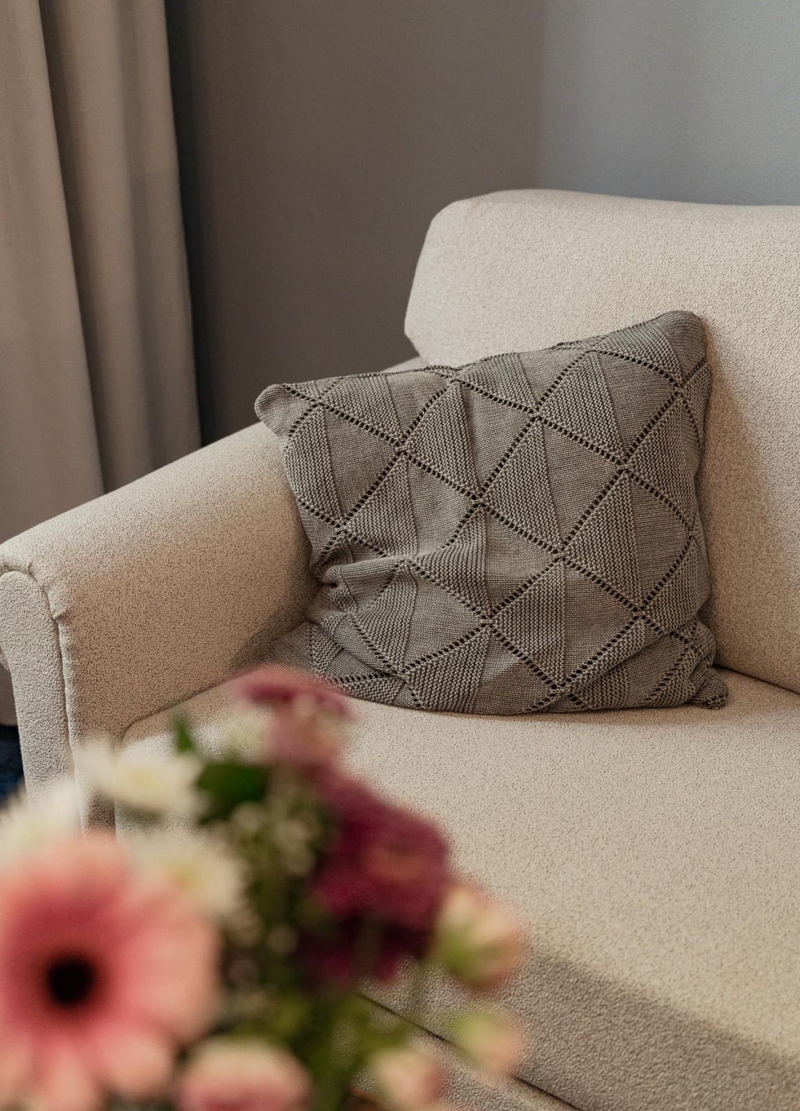 Detailed shot the couch in the comfy room, which helps guests to relax after a long day.