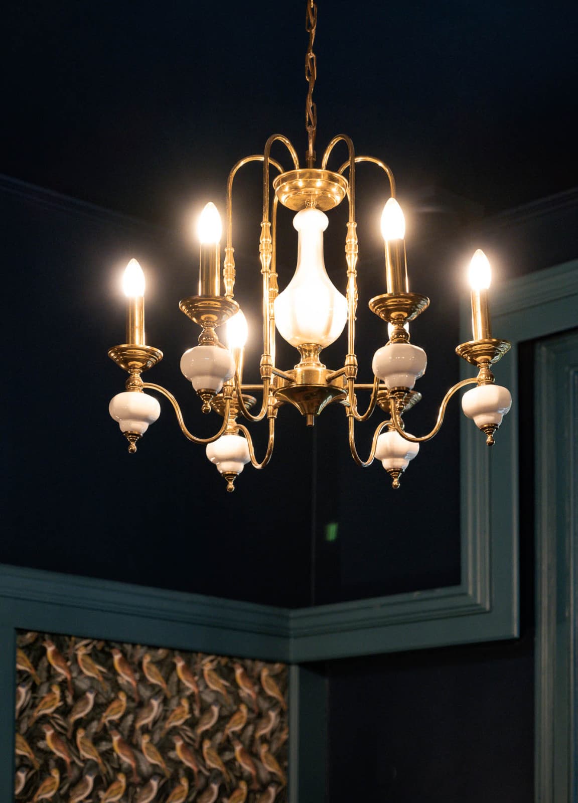 The pictures shows a detailed shot of the historic chandelier hanging in the lounge area of the hotel. It shows the how grand the Villa used to be.