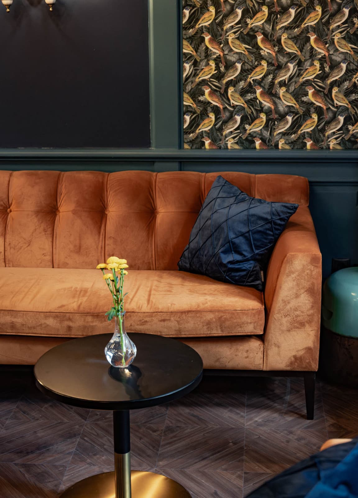 Seen is a shot of the iconic orange sofas, which are located in the lounge. Complimented by the dark blue wallpaper, the art deco style is shown throughout the whole hotel.