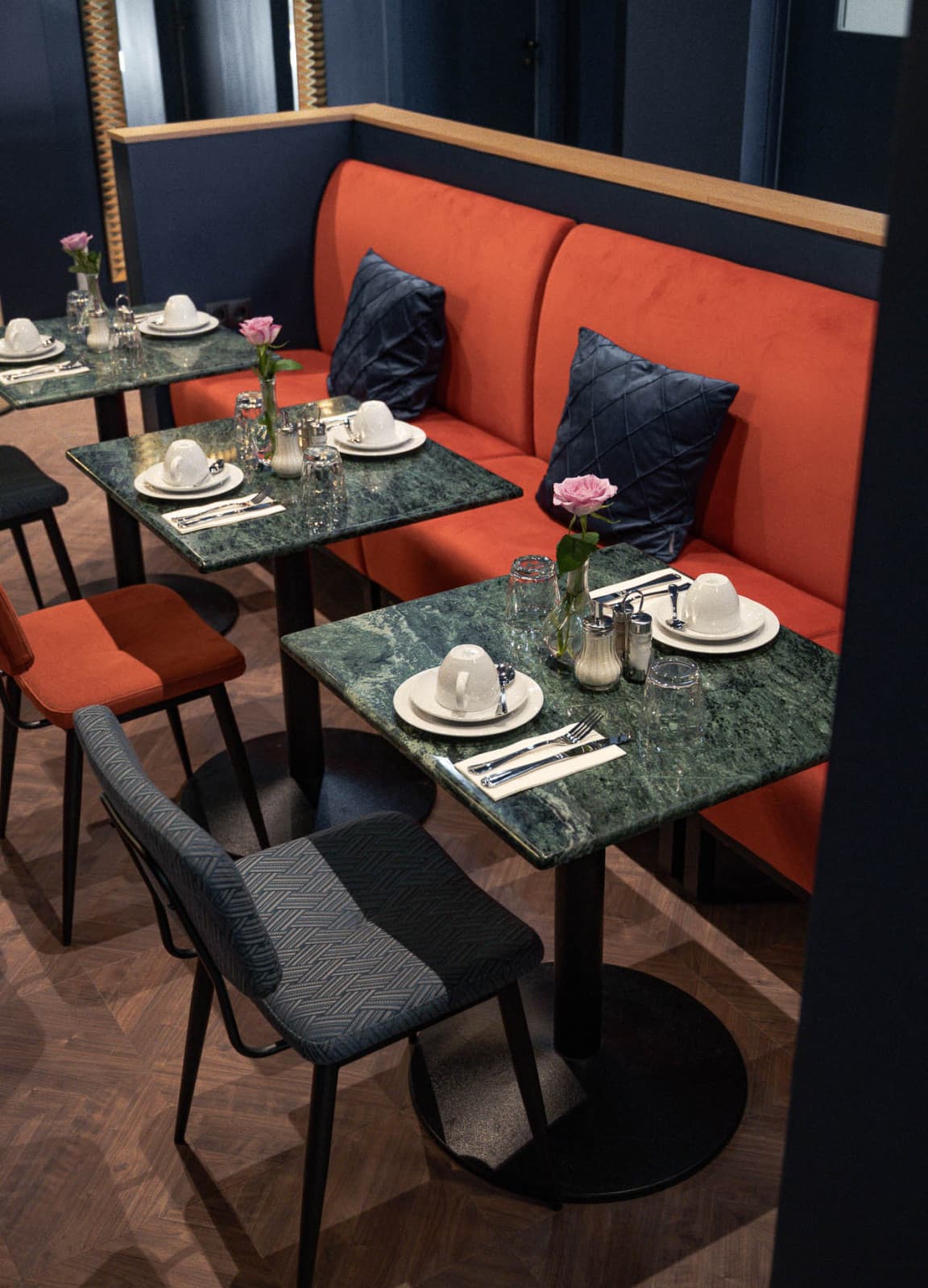 Seen is the breakfast area of the hotel which is located in the lobby. The tables are set for guests to arrive and eat the Buffett.