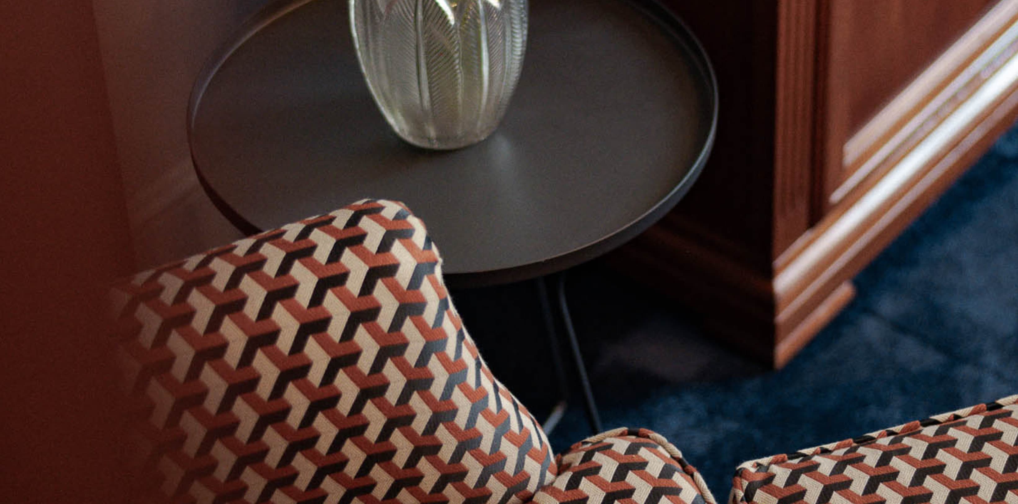 Shown is a detail picture of a beautifully restored armchair, that invites the guests to relax and enjoy the villa after a long day.