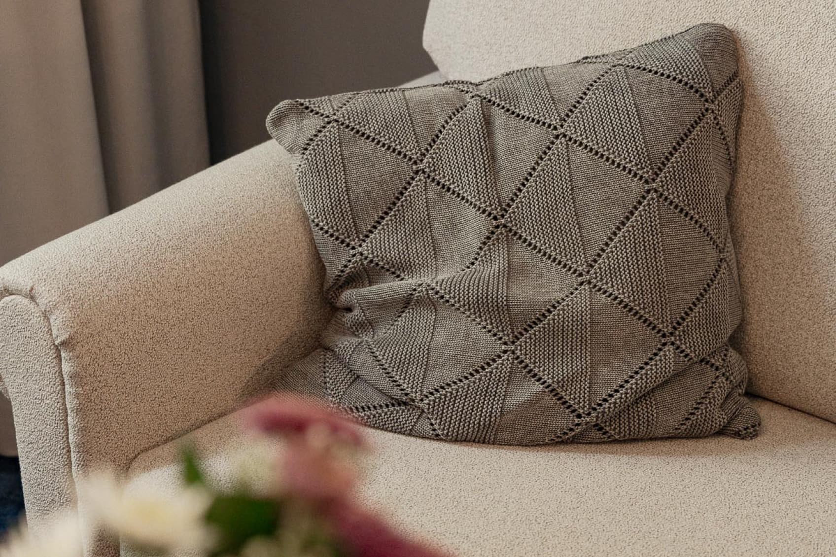 Seen is a prt of the couch that is opposite the bed and invites guests to relax and read a book after a day of sightseeing.