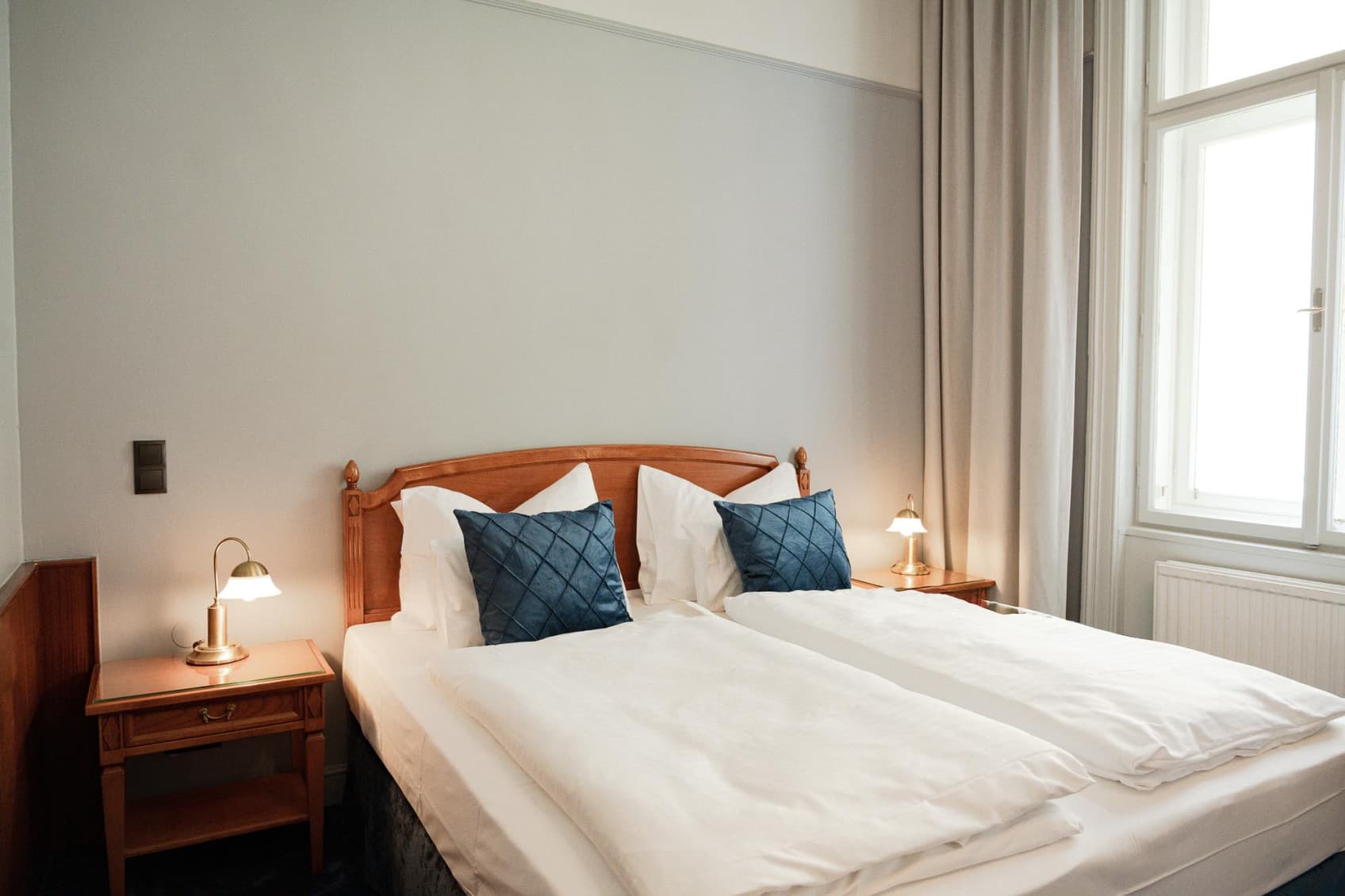 Seen is the Double bed of the category Comfy, which is suited or two people. The background tones are softer blues and greys.