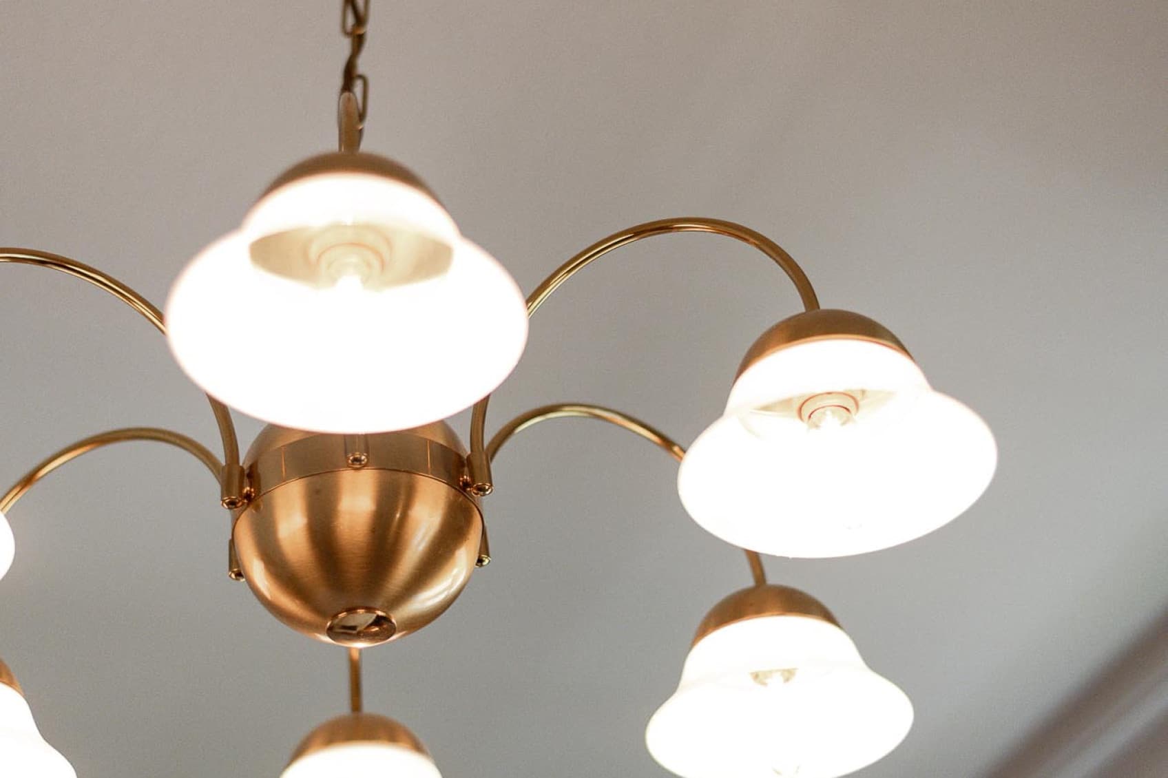 Seen is a detail shot of a restored golden chandelier, that shows the beauty and charme of the Viennese Villa