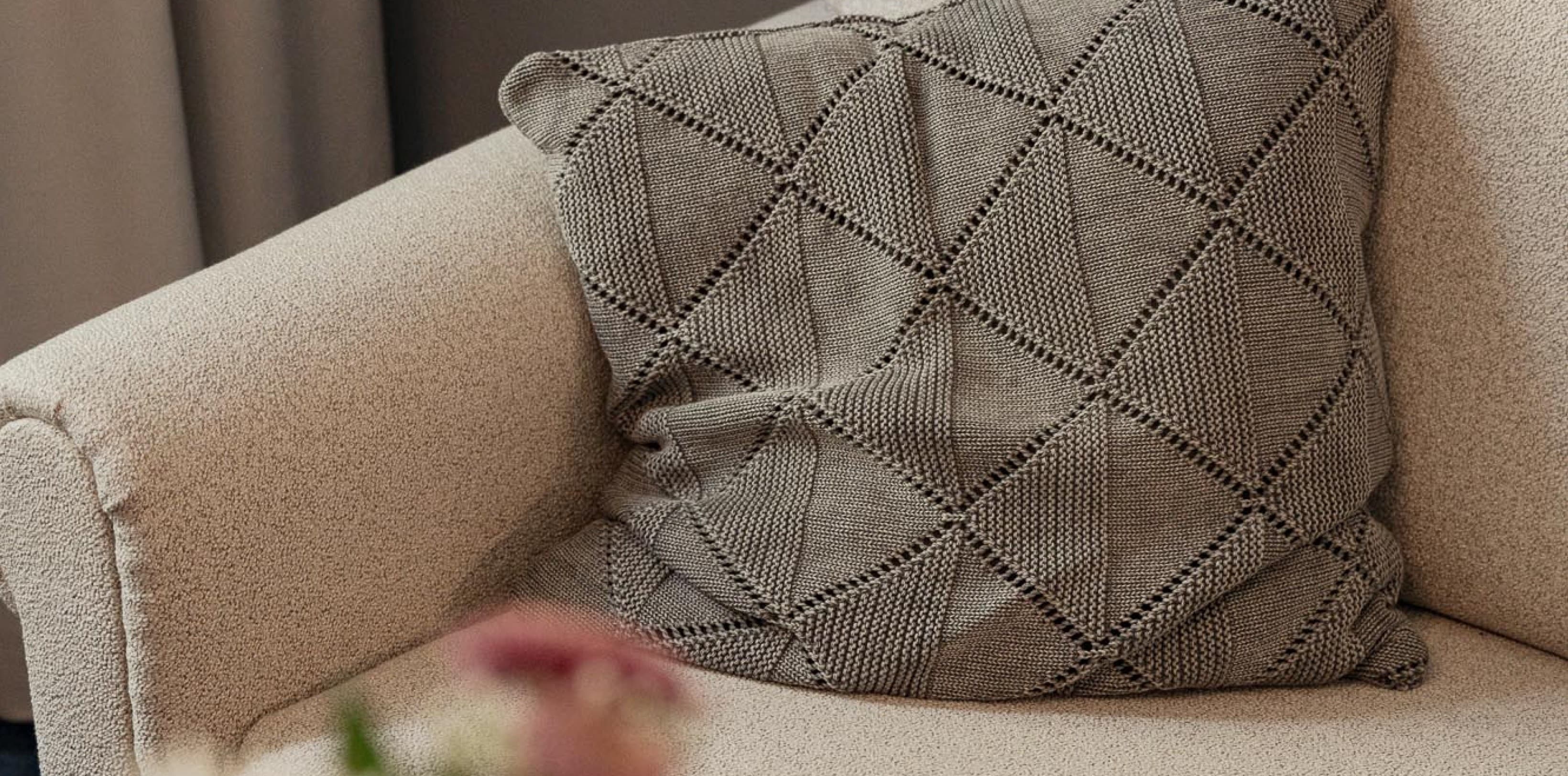 Seen is a prt of the couch that is opposite the bed and invites guests to relax and read a book after a day of sightseeing.